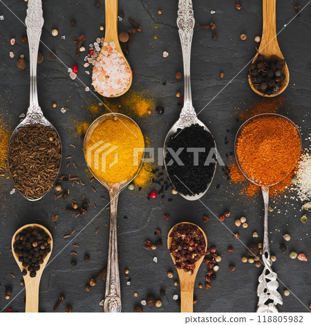 Exotic spices on spoons in a square 118805982