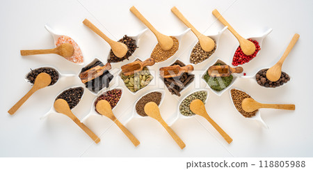 Exotic spices in bowls with small wooden spoons 118805988