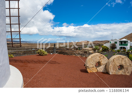 View past the windmill into the vast volcanic landscape in the cactus garden Jardin de Cactus of Lanzarote 118806134