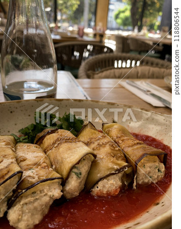Grilled Eggplant Rolls Stuffed with Creamy Filling on Tomato Sauce. High quality photo Grilled Eggplant Rolls Stuffed with Creamy Filling on Tomato Sauce. High quality photo 118806544