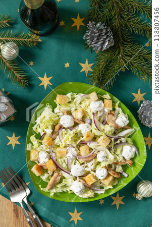 Christmas appetizer New year meal idea. Christmas appetizer. Christmas New Year salad chinese cabbage, feta cheese, chicken and croutons on rustic table. Christmas appetizer New year meal idea. Christmas appetizer. Christmas New Year salad chinese cabbage, feta cheese, chicken and croutons on rustic table. 118807456