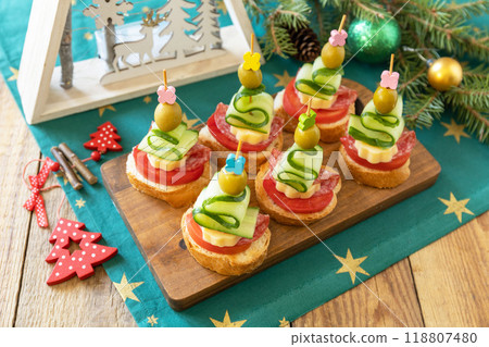 Creative appetizers christmas. Canapes Christmas tree of salami, cheese, olives, tomatoes and cucumbers with baguette on a rustic table. 118807480