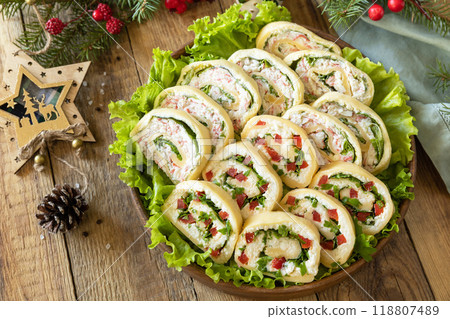 Creative appetizers christmas. Cheese roll with cream cheese, sweet pepper and greens. 118807489