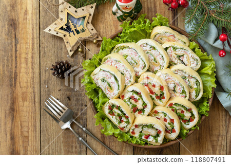 Creative appetizers christmas. Cheese roll with cream cheese, sweet pepper and greens. Creative appetizers christmas. Cheese roll with cream cheese, sweet pepper and greens. 118807491
