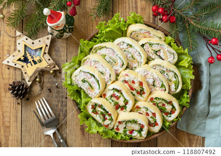 Creative appetizers christmas. Cheese roll with cream cheese, sweet pepper and greens. Creative appetizers christmas. Cheese roll with cream cheese, sweet pepper and greens. 118807492