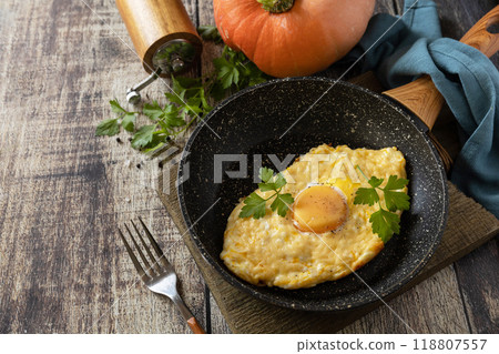 Khachapuri, baked cottage cheese pumpkin bread with cheese and egg filling on rustic wooden table. Khachapuri, baked cottage cheese pumpkin bread with cheese and egg filling on rustic wooden table. 118807557