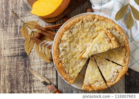 Fall traditional pumpkin pie with cinnamon on a rustic wooden background. Fall traditional pumpkin pie with cinnamon on a rustic wooden background. 118807603
