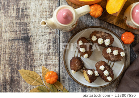 Chocolate rum potato cake with pumpkin on rustic background, homemade vegan dessert. Traditional Eastern European dish with cocoa and butter. Chocolate sweets filled with marzipan. View from above. 118807650