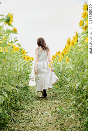 Portrait of a woman in a sunflower field 118808030