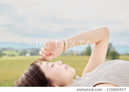 A young woman lying down with nature in the background 118808457