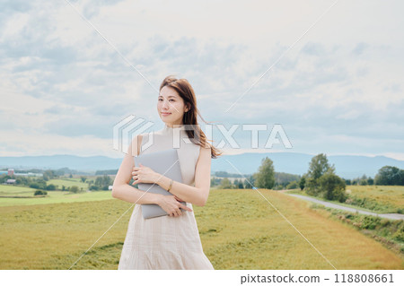 Woman with a PC in nature 118808661