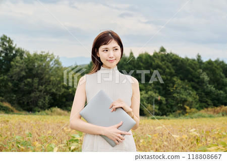 Woman with a PC in nature 118808667