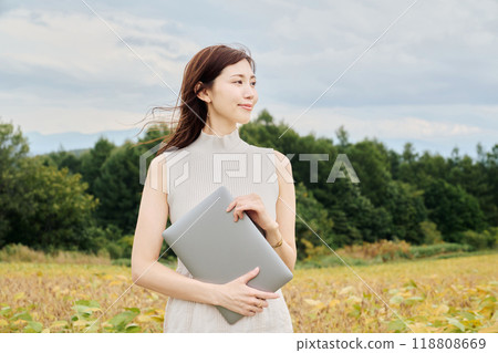 Woman with a PC in nature Woman with a PC in nature 118808669