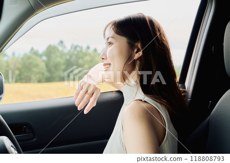Woman driving in the wilderness Woman driving in the wilderness 118808793