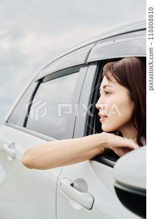 woman looking out of car window woman looking out of car window 118808810