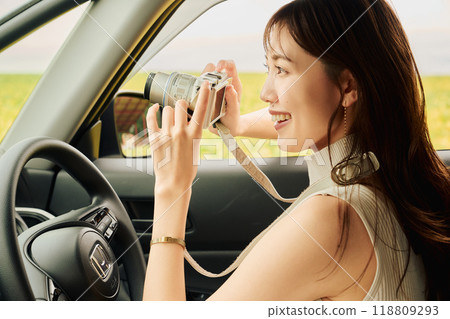 Young woman taking a photo from inside the car Young woman taking a photo from inside the car 118809293