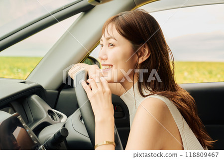 Woman driving in the wilderness Woman driving in the wilderness 118809467