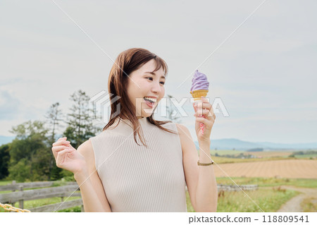 A woman eating a soft cream 118809541