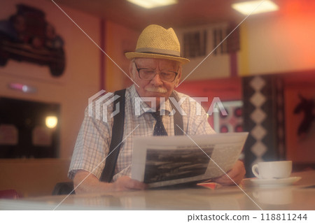 Reading Newspaper in Cozy Coffee Shop Setting 118811244