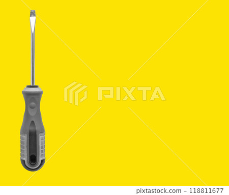 Carpenter holding screwdriver, tool for repair and maintenance. Yellow background with space for Carpenter holding screwdriver, tool for repair and maintenance. Yellow background with space for 118811677