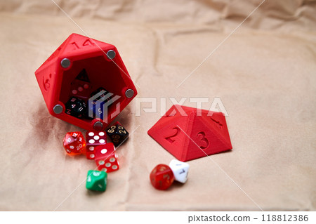 Diverse collection of colored dice on a cardboard surface 118812386