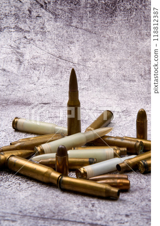 Composition of rounds of ammunition on floor 118812387