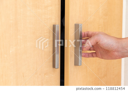 Grab the handle on one side of the double door Grab the handle on one side of the double door 118812454