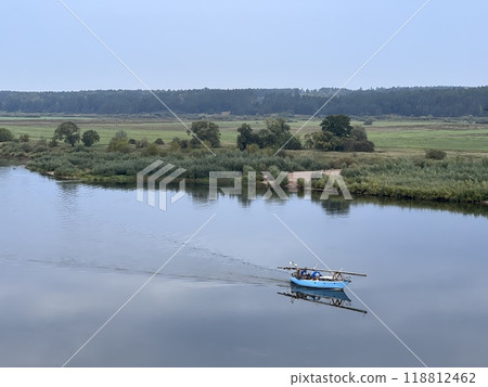 Lonely small boat in the river, shot in the air from hill in Lithuania, quit day, aerial 118812462