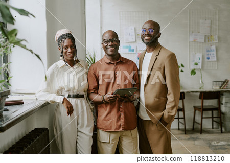 Portrait of smiling African American team posing for photo in modern office Portrait of smiling African American team posing for photo in modern office 118813210