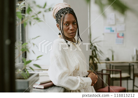 Confident African American businesswoman posing for portrait in office 118813212