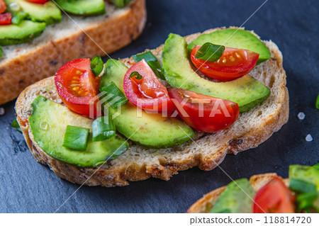 Avocado toast topped with tomato and green onion on a slice of carrot bread Avocado toast topped with tomato and green onion on a slice of carrot bread 118814720