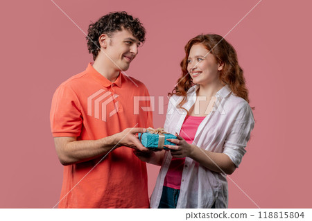 Young woman and man with gift box. Surprise, unexpected present. Birthday, celebration, surprise, anniversary concept. Young woman and man with gift box. Surprise, unexpected present. Birthday, celebration, surprise, anniversary concept. 118815804