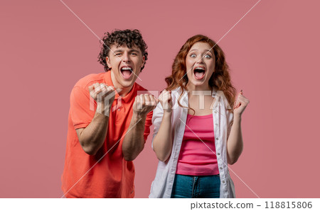 Pretty woman and man shows triumph yes yeah, hooray gesture of victory, achieved result, goals. Stylish couple glad, happy, surprised excited on pink background. Pretty woman and man shows triumph yes yeah, hooray gesture of victory, achieved result, goals. Stylish couple glad, happy, surprised excited on pink background. 118815806
