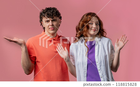 Confused man woman, couple shoulders up - can't help, makes gesture of dont know Confused man woman, couple shoulders up - can't help, makes gesture of dont know 118815828
