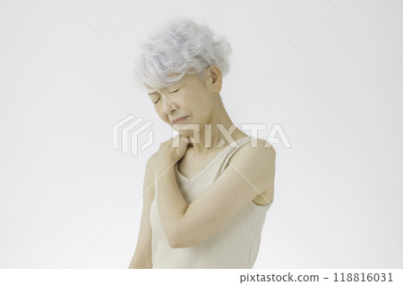 Gray-haired senior woman holding her shoulders, stiff shoulders Gray-haired senior woman holding her shoulders, stiff shoulders 118816031