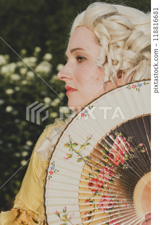 Portrait of blonde woman dressed in historical Baroque clothes with old fashion hairstyle Portrait of blonde woman dressed in historical Baroque clothes with old fashion hairstyle 118816681