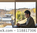 A man working remotely on a computer 118817306