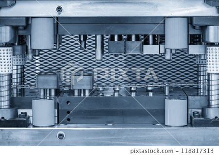 The  stamping operation of metal drawing process on the progressive die in the light blue scene. 118817313