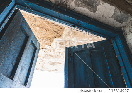 The open, blue doors of the main entrance, to an abandoned, rustic store The open, blue doors of the main entrance, to an abandoned, rustic store 118818007