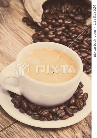 Coffee in white cup and roasted dark coffee beans Coffee in white cup and roasted dark coffee beans 118818624