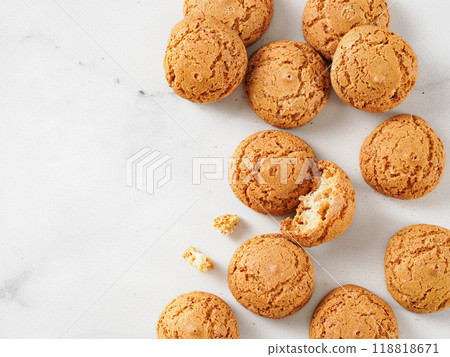 pile of cookie amaretti on white marble background - traditional Italian Sardinian pastry. Delicious amaretti biscuit cookies made from almond or apricot kernels with copy space 118818671