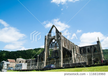 Tintern Abbey, a much crumbling historic stone site under a bright blue sky, in rural South Wales Tintern Abbey, a much crumbling historic stone site under a bright blue sky, in rural South Wales 118818960