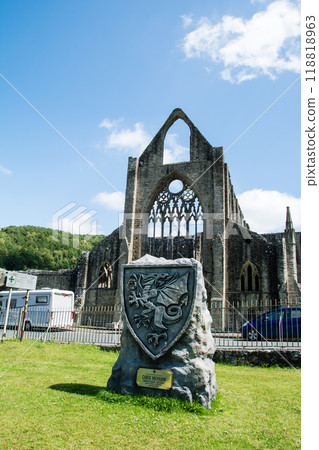 Tintern Abbey, a much crumbling historic stone site under a bright blue sky, in rural South Wales 118818963