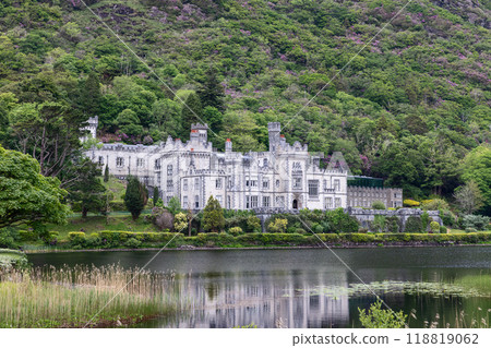 Kylemore Abbey in Connemara reflects on calm waters of Pollacapall Lough surrounded by lush greenery Kylemore Abbey in Connemara reflects on calm waters of Pollacapall Lough surrounded by lush greenery 118819062
