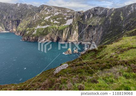 Isolated cove at Slieve League cliffs featuring steep rocky outcrops calm waters of the Atlantic 118819068