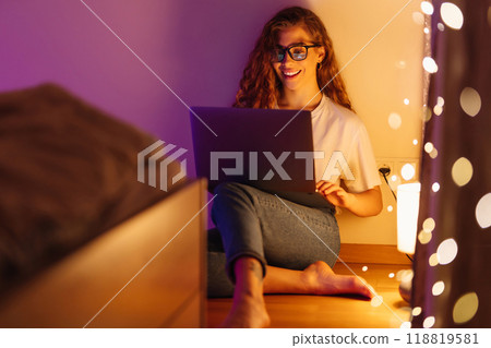 Woman working online on laptop computer at home. Business, blogging, freelance, education concept. Woman working online on laptop computer at home. Business, blogging, freelance, education concept. 118819581
