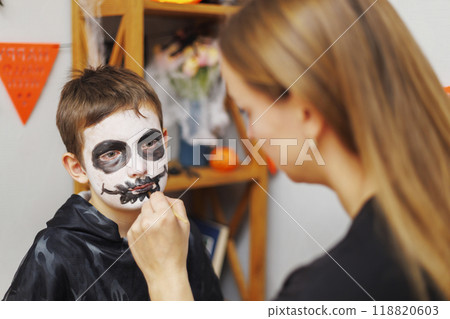 Boy getting face painted for Halloween Boy getting face painted for Halloween 118820603