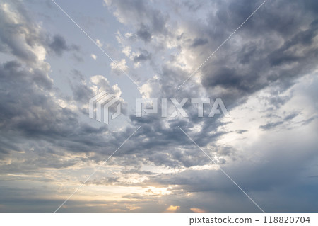 A dramatic and moody sky filled with dark, swirling clouds 118820704