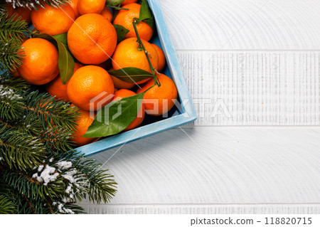 Festive citrus joy: Tangerines in a holiday-themed box Festive citrus joy: Tangerines in a holiday-themed box 118820715