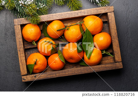 Festive citrus joy: Tangerines in a holiday-themed box Festive citrus joy: Tangerines in a holiday-themed box 118820716